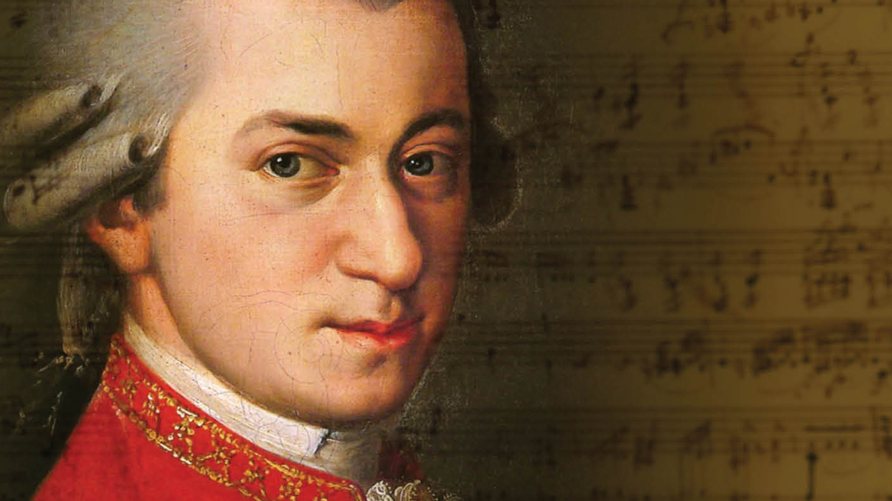 Mozart's face in front one of his compositions.